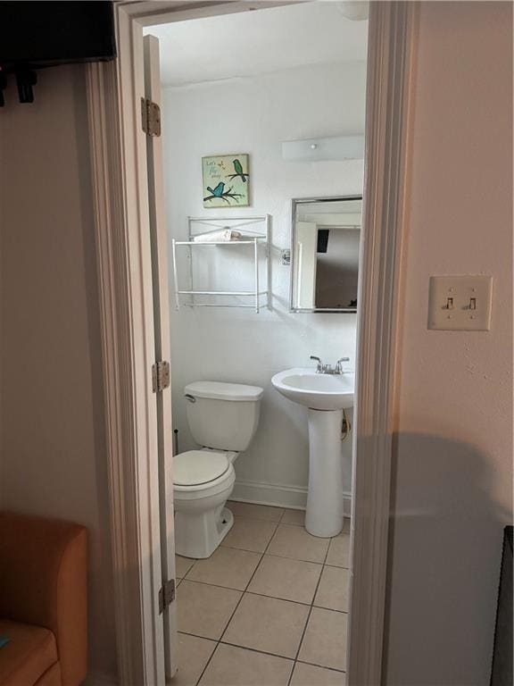 bathroom with tile patterned flooring and toilet