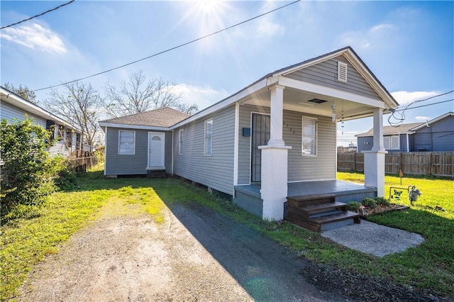 bungalow-style home with a porch and a front lawn