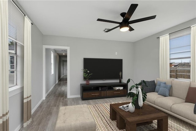 living room featuring ceiling fan and light hardwood / wood-style flooring