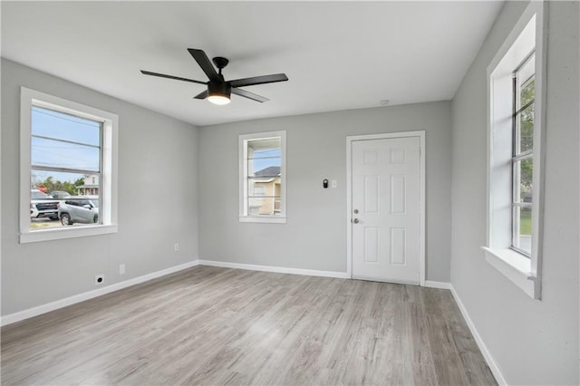 unfurnished room featuring light wood-type flooring, plenty of natural light, and ceiling fan