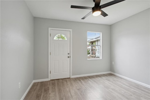 foyer featuring light hardwood / wood-style floors, a wealth of natural light, and ceiling fan