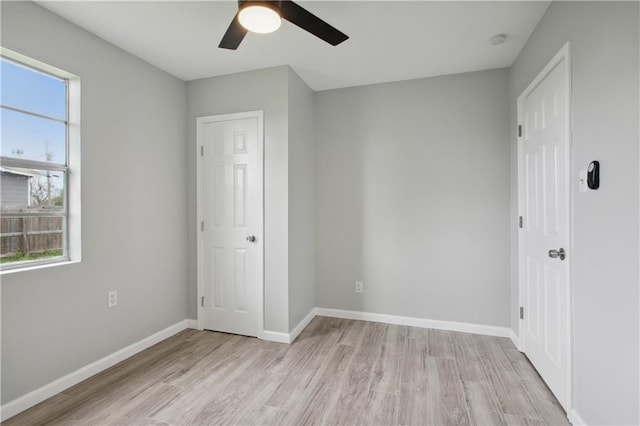 unfurnished bedroom featuring light wood-type flooring and ceiling fan