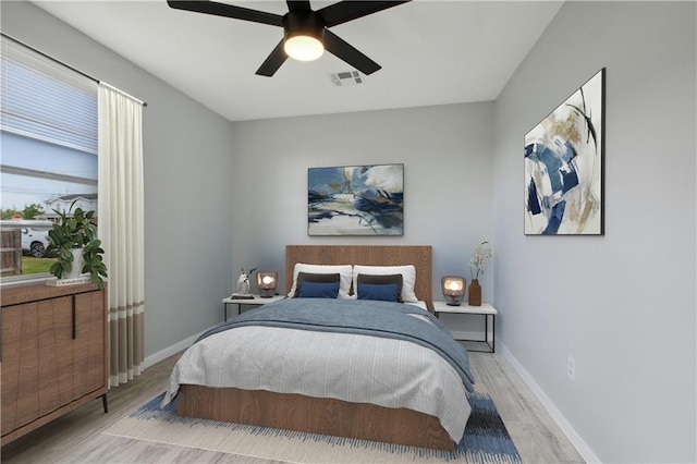 bedroom with light hardwood / wood-style flooring and ceiling fan