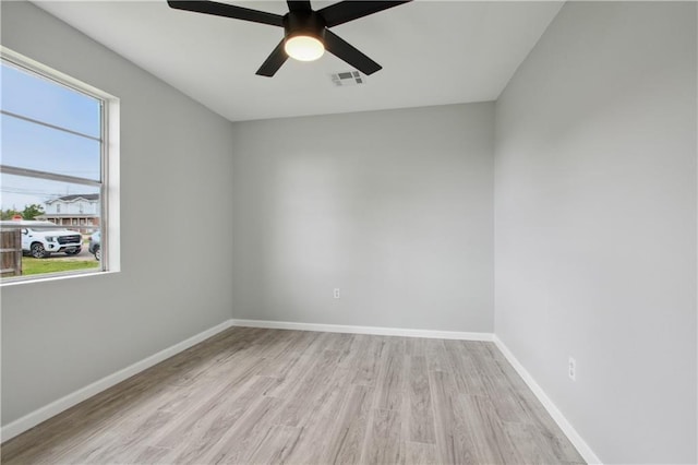 empty room with ceiling fan and light hardwood / wood-style flooring