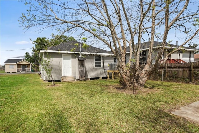 back of house with a lawn