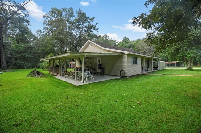 back of house with a yard and a patio area