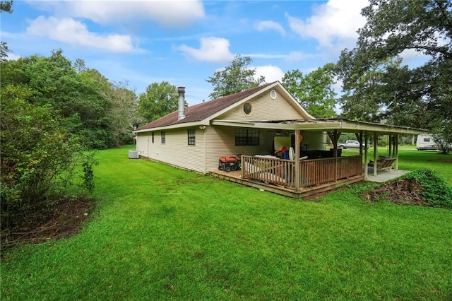 back of property featuring a lawn, a deck, and central air condition unit