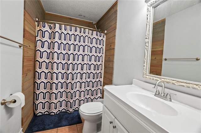 bathroom with curtained shower, vanity, a textured ceiling, wooden walls, and toilet