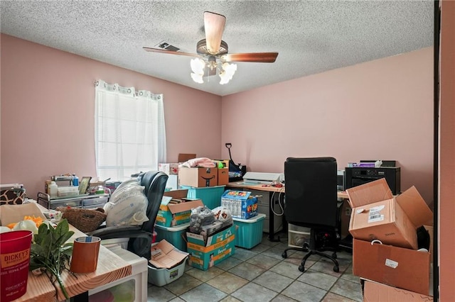 tiled office with a textured ceiling and ceiling fan