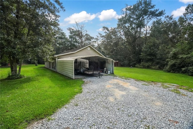 exterior space with a lawn and a carport