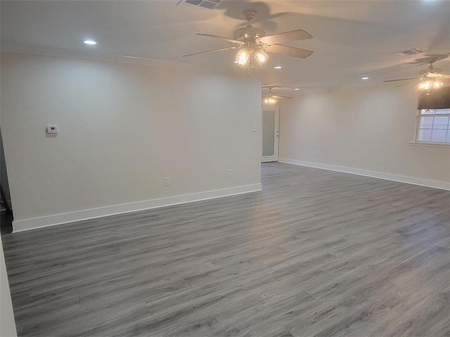 empty room featuring ceiling fan, ornamental molding, and hardwood / wood-style floors