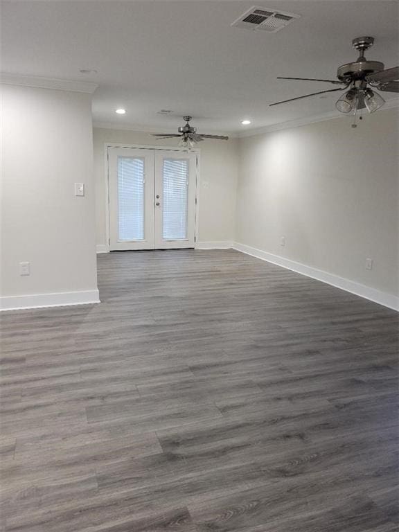 spare room featuring ornamental molding, dark wood-type flooring, ceiling fan, and french doors