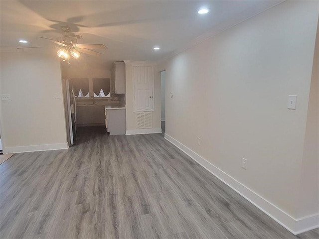 4985 Feliciana Dr, New Orleans, LA 70126 - unfurnished living room featuring baseboards, ceiling fan, recessed lighting, light wood-type flooring, and crown molding