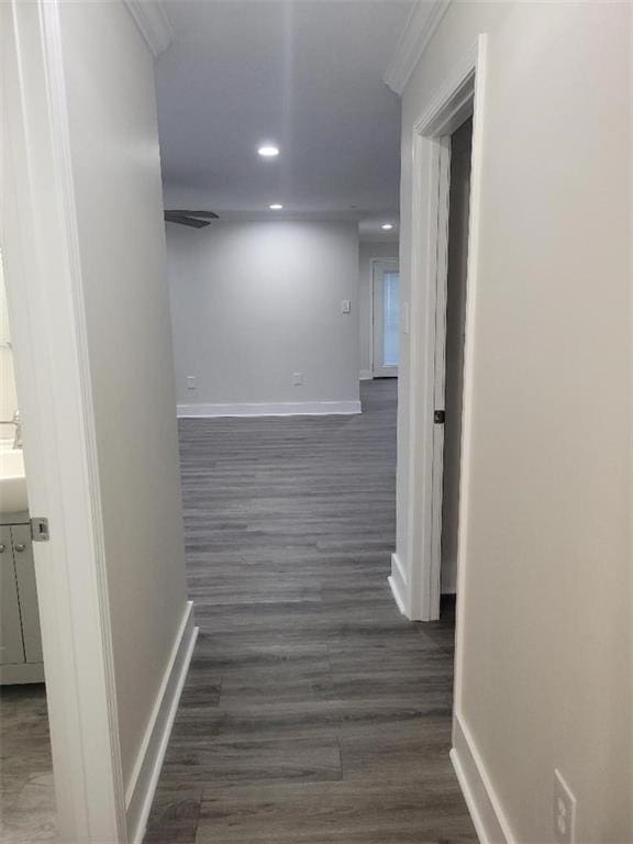 hallway with ornamental molding and dark hardwood / wood-style floors