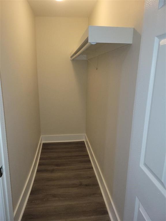 4985 Feliciana Dr, New Orleans, LA 70126 - walk in closet with dark wood-type flooring