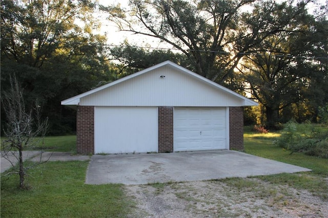 garage featuring a lawn