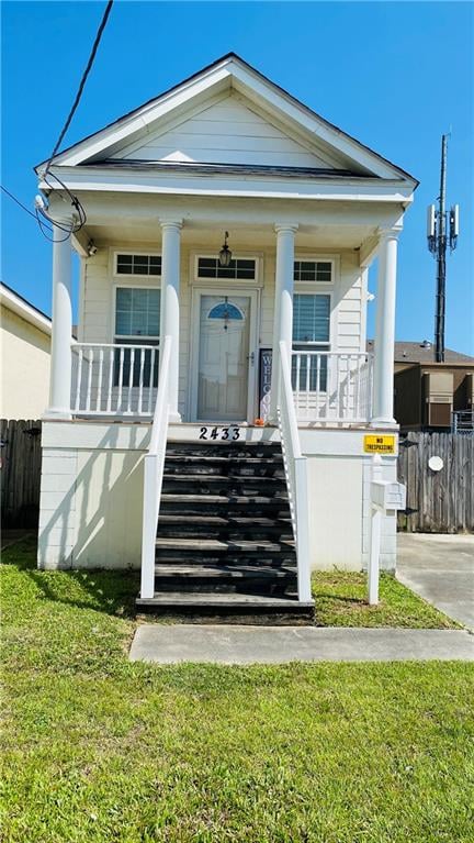 property entrance featuring a porch and a lawn