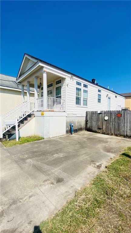 view of side of home with a porch