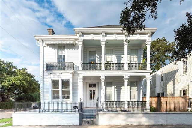 neoclassical / greek revival house with a balcony and a porch