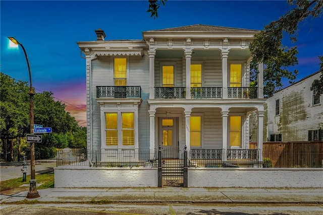 view of front facade featuring a balcony and covered porch