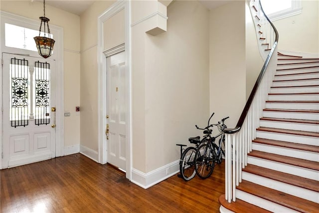 foyer featuring an inviting chandelier and dark hardwood / wood-style floors