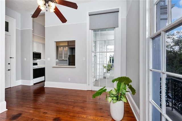 foyer with ceiling fan and dark wood-type flooring