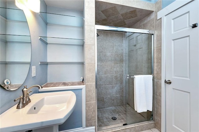 bathroom featuring walk in shower and sink