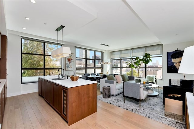 kitchen featuring oven, sink, pendant lighting, stainless steel gas stovetop, and tasteful backsplash