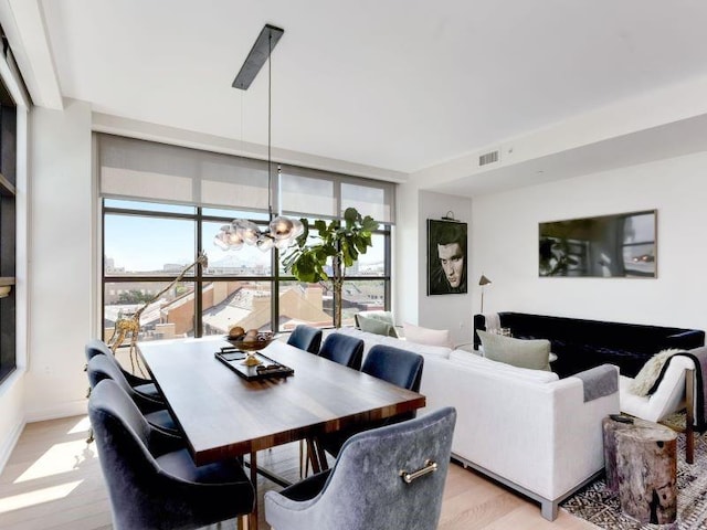 dining space with a healthy amount of sunlight and light wood-type flooring