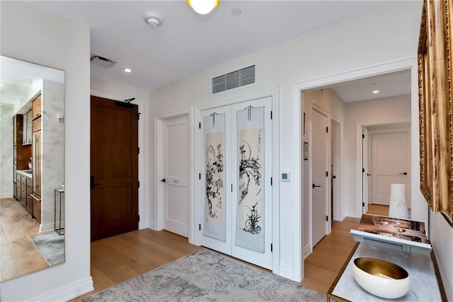 hall with light hardwood / wood-style floors