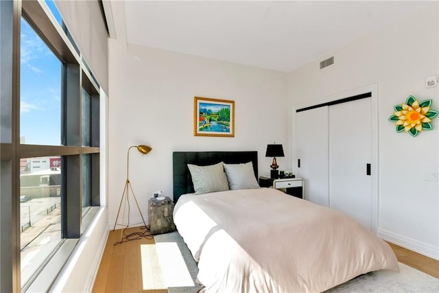 bedroom featuring a closet and light wood-type flooring