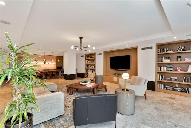 living room with a chandelier and built in features