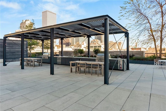 view of patio with fence, a pergola, outdoor dining space, and grilling area