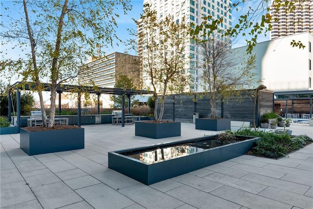 view of patio / terrace with a fire pit and a pergola