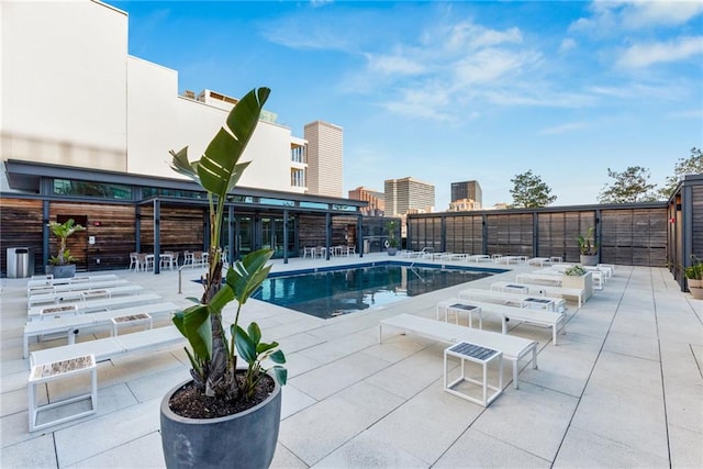 community pool featuring a patio area and fence