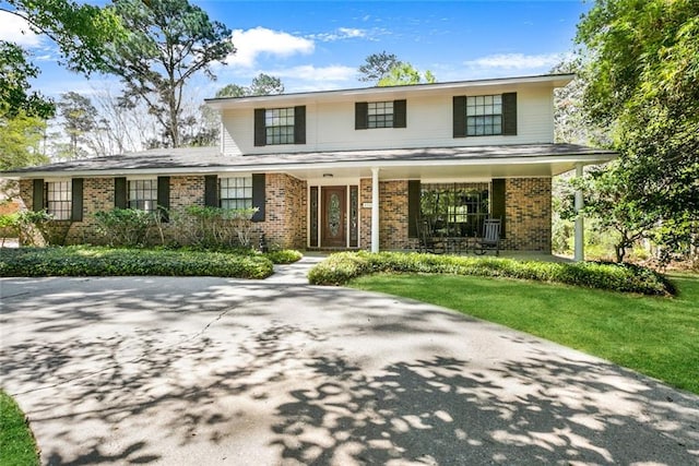 front of property with a front yard and covered porch