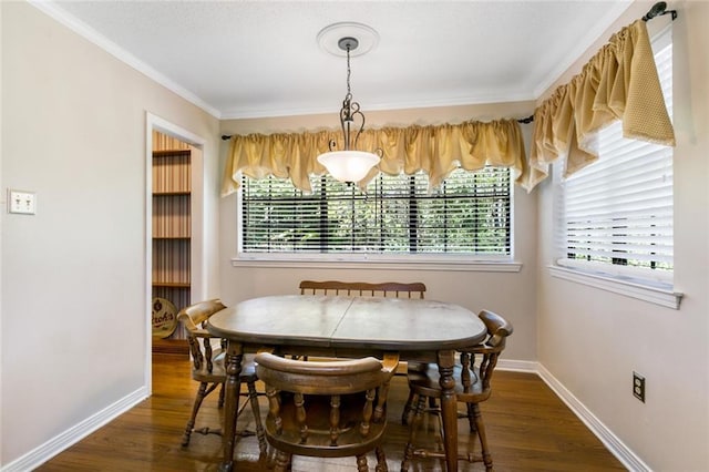 dining room featuring ornamental molding and dark hardwood / wood-style flooring