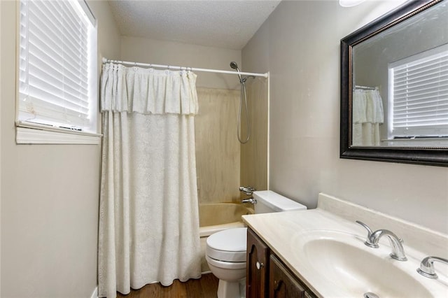 full bathroom with shower / bath combo, a textured ceiling, hardwood / wood-style floors, vanity, and toilet