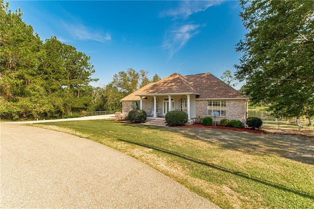 view of front of house with covered porch and a front yard