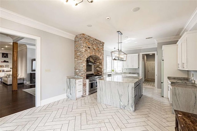 kitchen featuring a kitchen island, ornamental molding, and white cabinetry