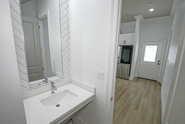 bathroom with sink and hardwood / wood-style flooring