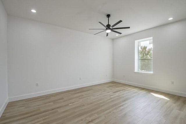 unfurnished room featuring ceiling fan and light hardwood / wood-style flooring