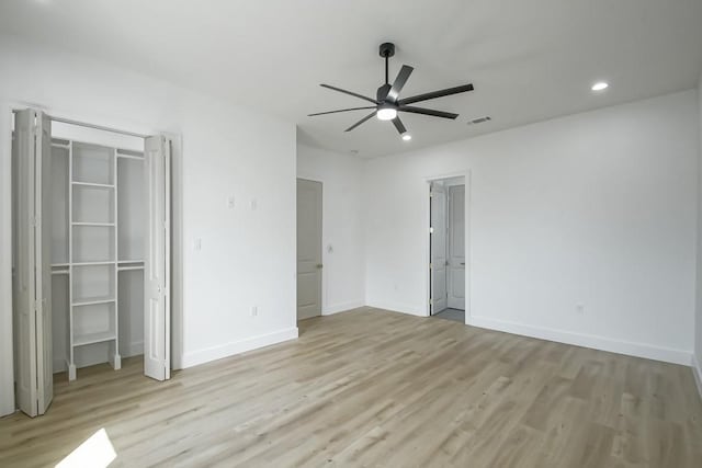 unfurnished bedroom with ceiling fan and light hardwood / wood-style floors