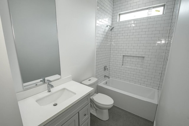 full bathroom with tiled shower / bath, vanity, tile patterned flooring, and toilet