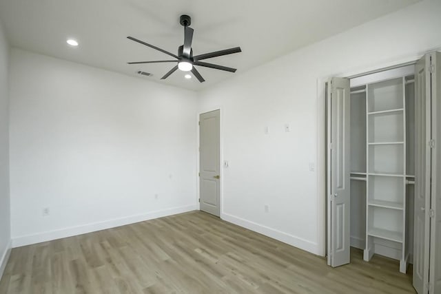 unfurnished bedroom featuring light wood-type flooring, ceiling fan, and a closet