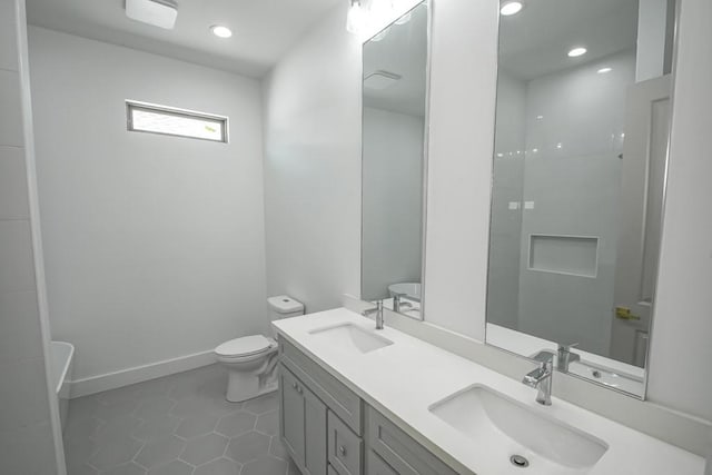 bathroom featuring vanity, toilet, and tile patterned floors