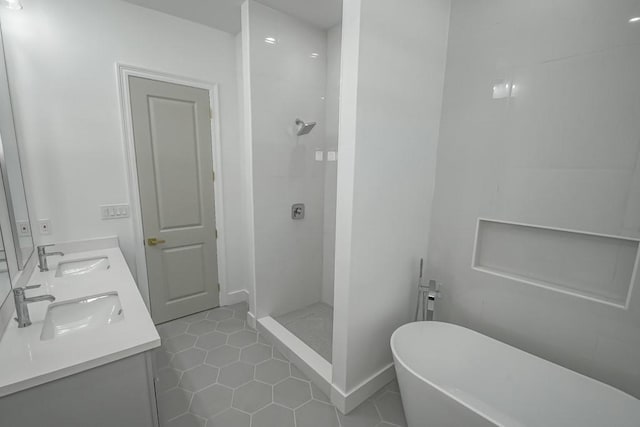 bathroom featuring tile patterned flooring, vanity, and plus walk in shower