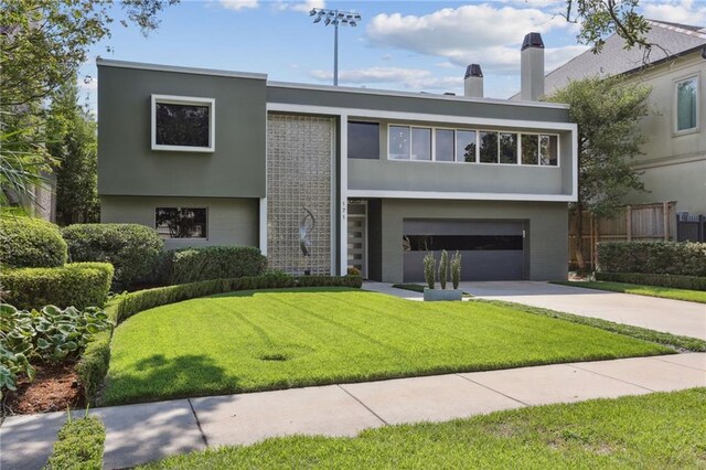 view of front of property with a front yard and a garage