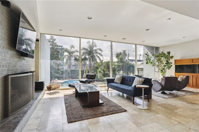 interior space featuring a brick fireplace and floor to ceiling windows