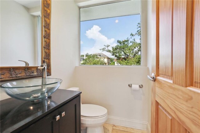 bathroom with vanity, tile patterned flooring, and toilet